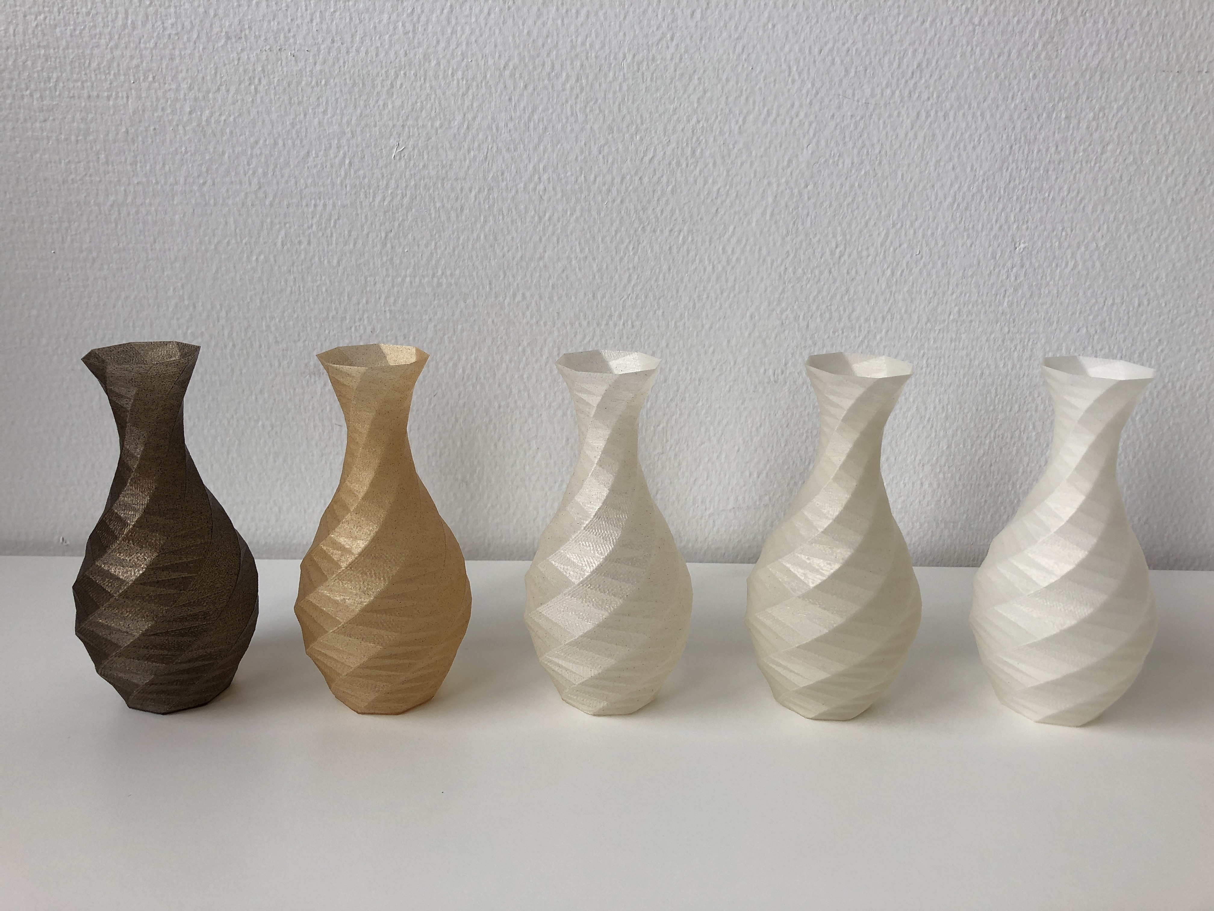 Vases printed with biocomposed filaments.