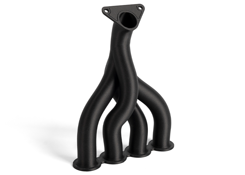 Exhaust manifold printed with XECARB PA12-CF-ST filament. Source: Xenia Materials
