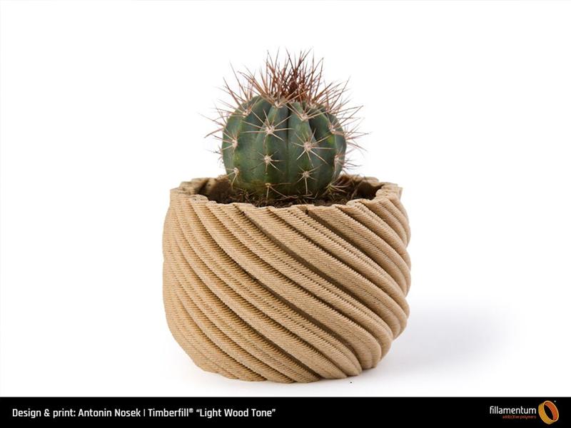 A plant pot 3D printed with the Timberfill Light Wood Tone
